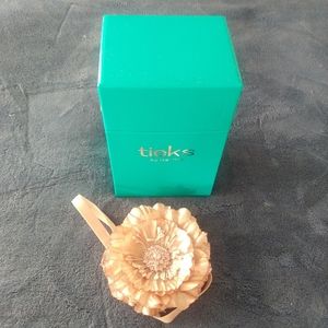 Empty Tieks box and champagne/rose gold pink flower topper